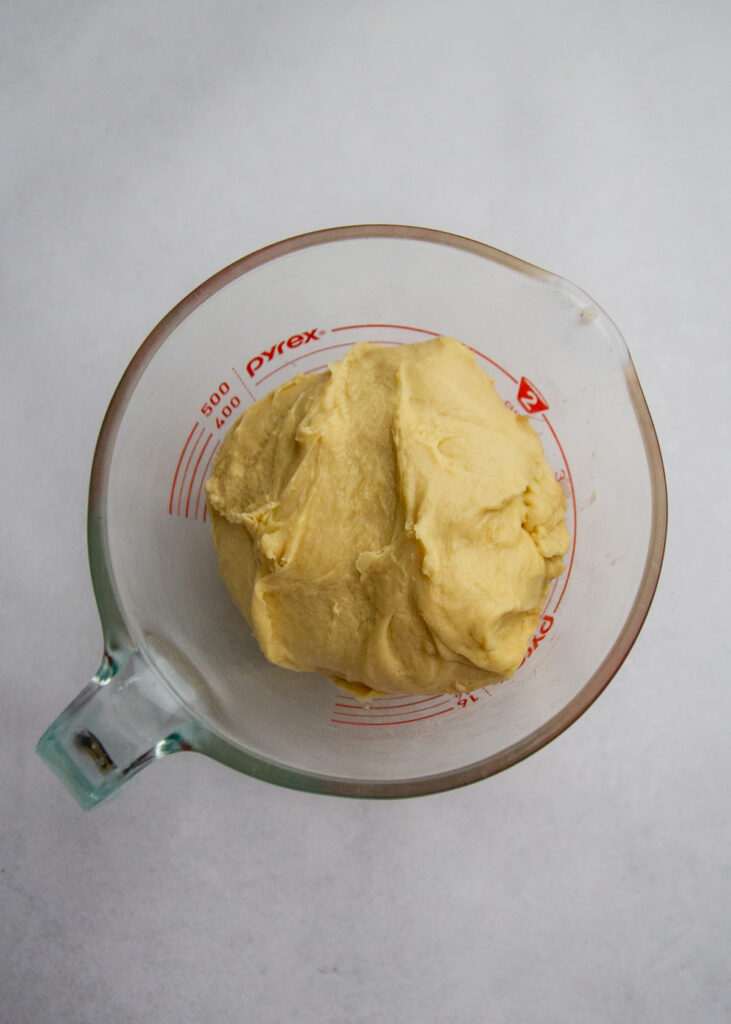 Dough in a measuring cup.