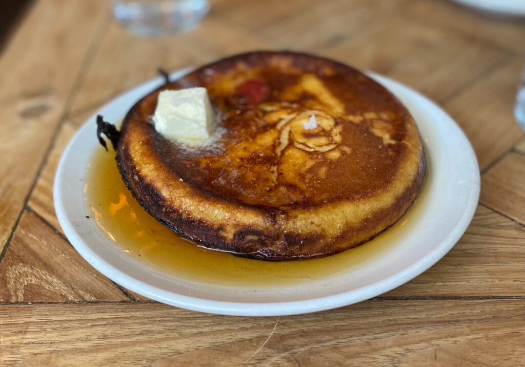 A sourdough pancake topped with melted butter from Vinegar Hill House.