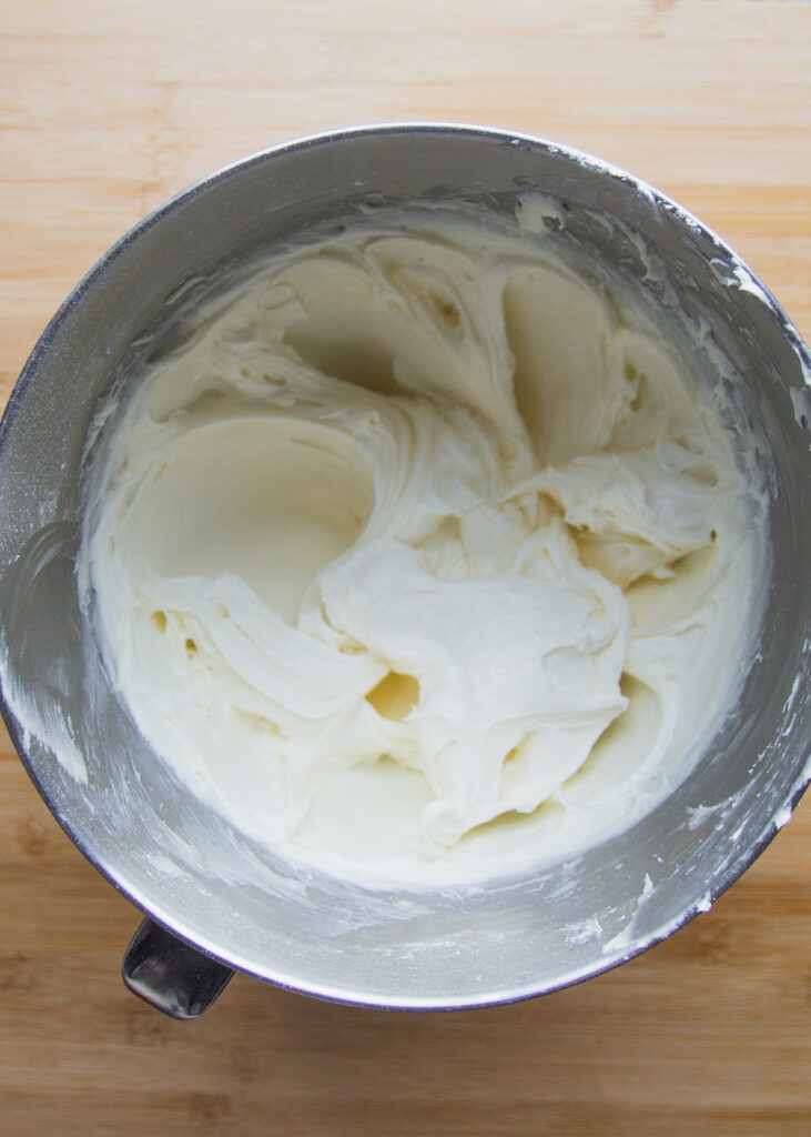 whipped cream cheese frosting in a mixing bowl.