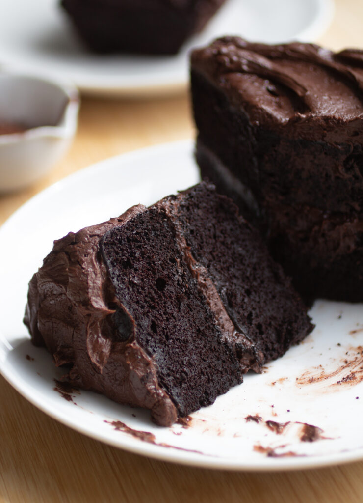a slice of double chocolate black bean cake on a white plate.
