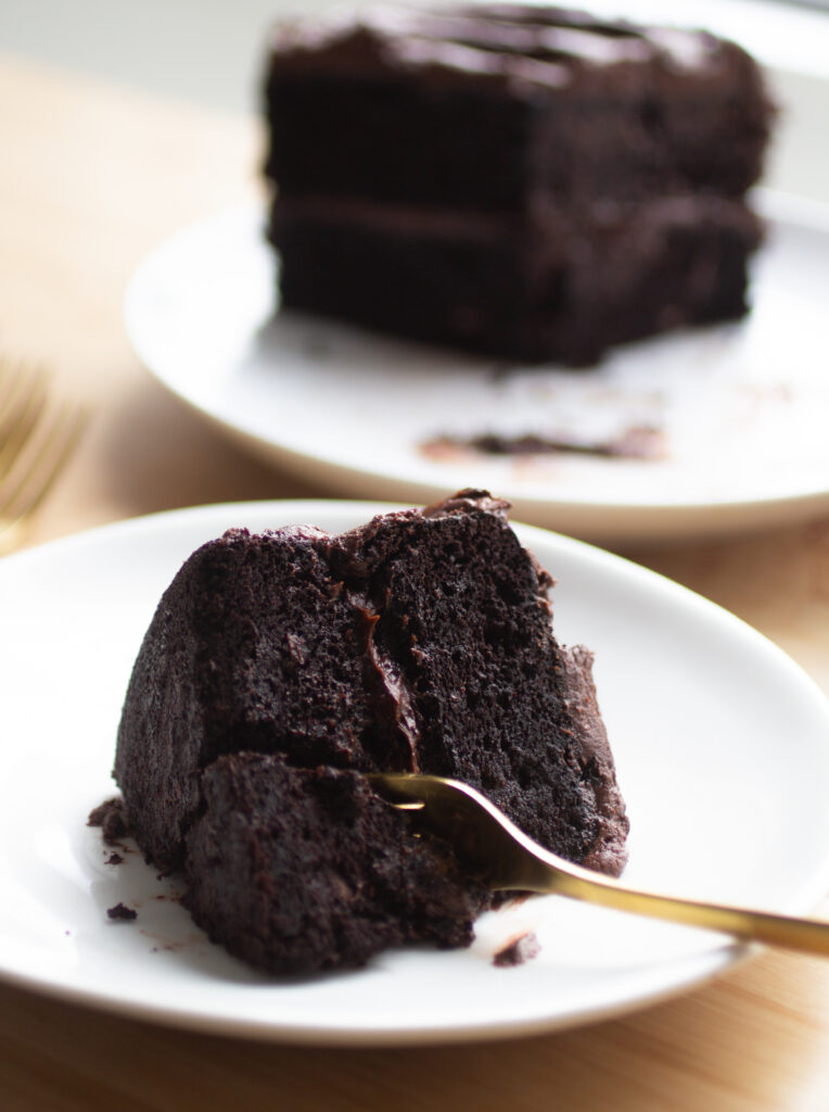 a slice of double chocolate black bean cake on a white plate.