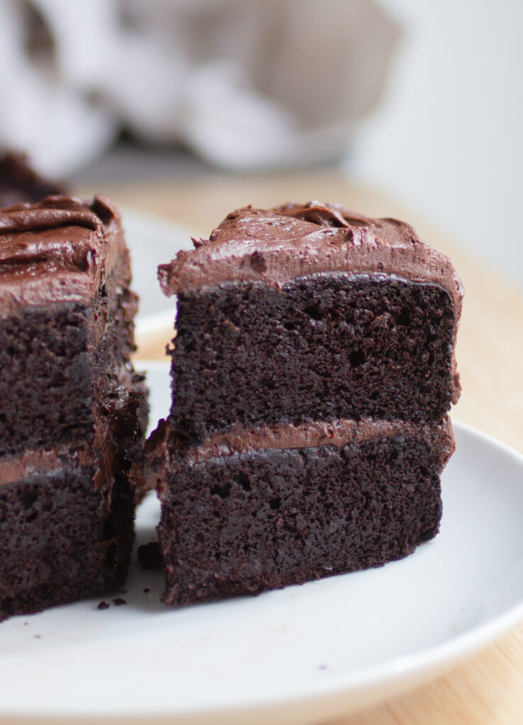 a slice of double chocolate black bean cake on a white plate.