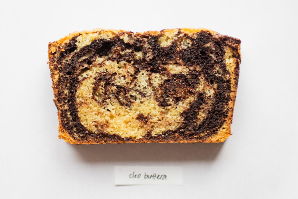 a slice of cleo buttera marble cake on a white background.