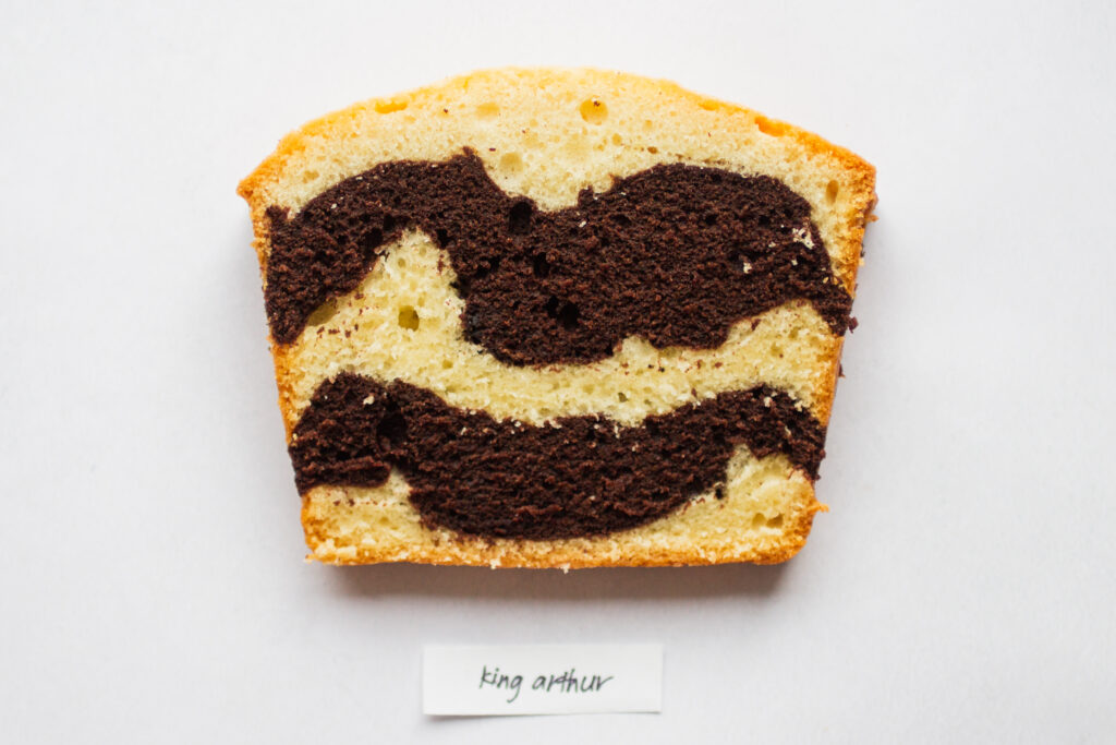 a slice of king arthur marble cake on a white background.