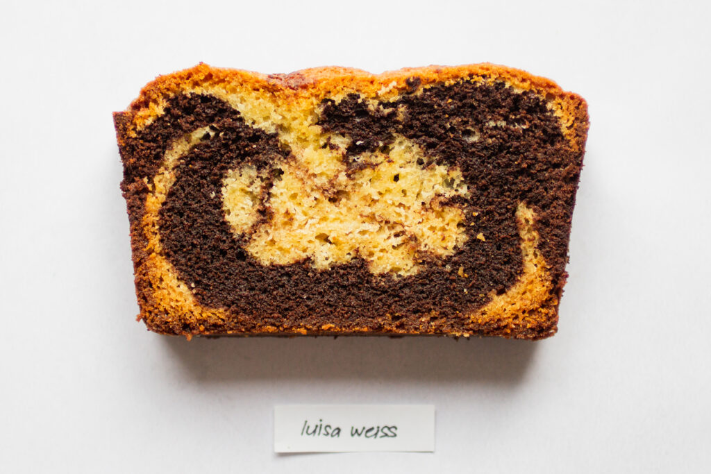 a slice of luisa weiss marble cake on a white background.