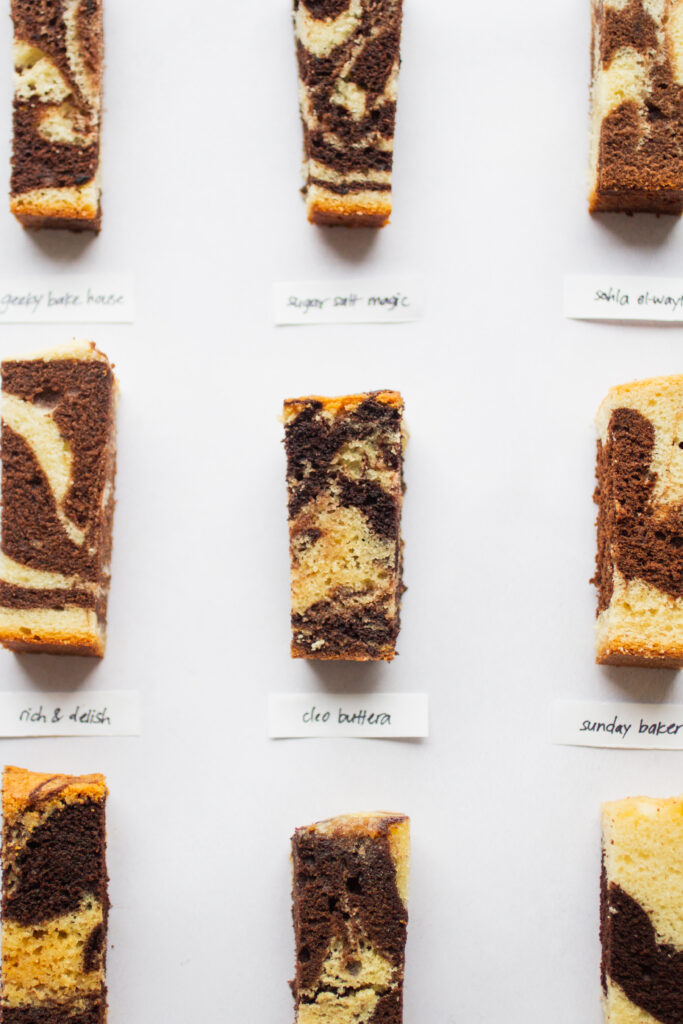 9 different slices of marble cake on a gray background.