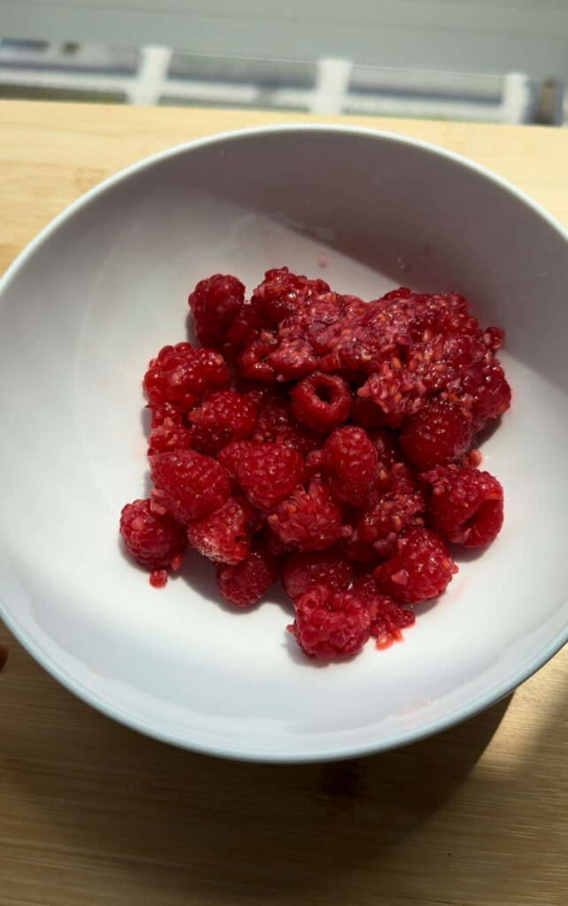 raspberries in a white bowl.