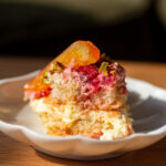 a slice of blood orange and raspberry tiramisu on a plate.