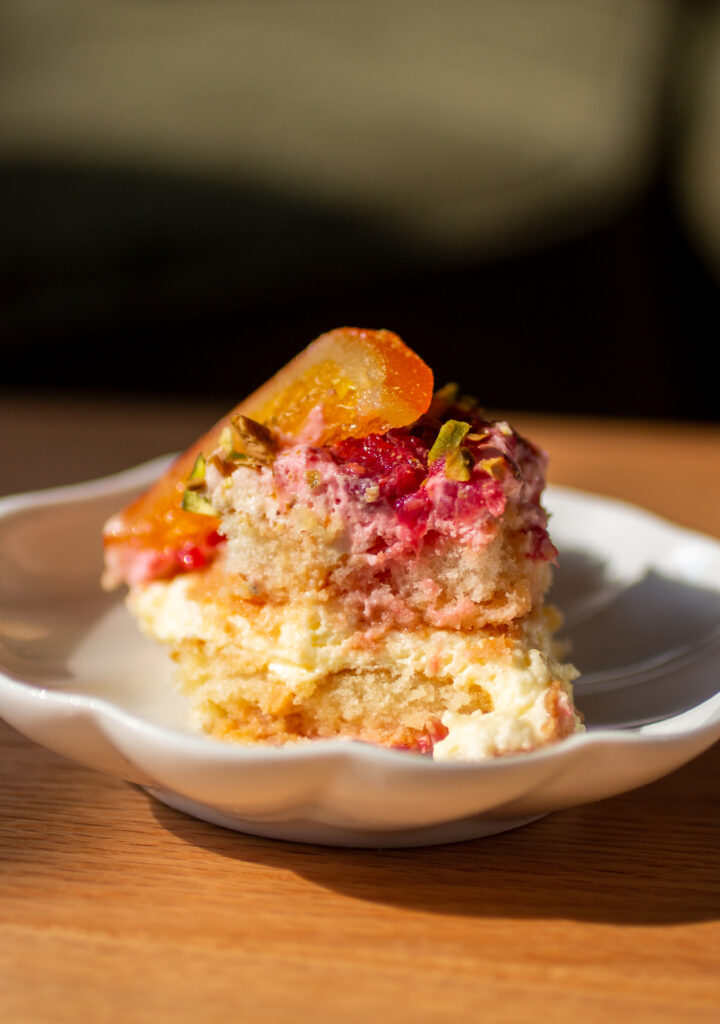 a slice of blood orange and raspberry tiramisu on a plate.