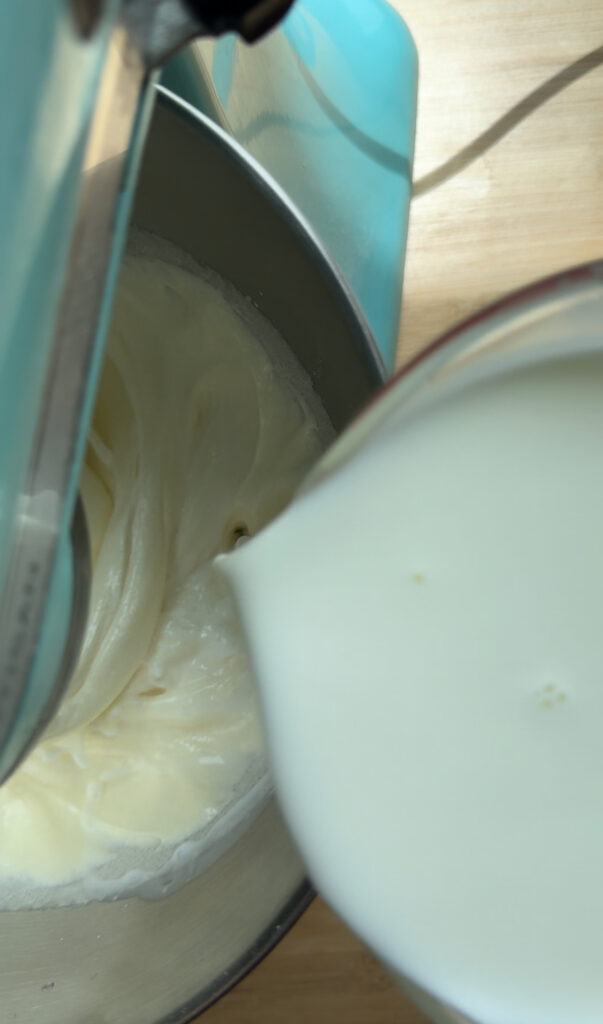 Adding milk into the egg mixture.