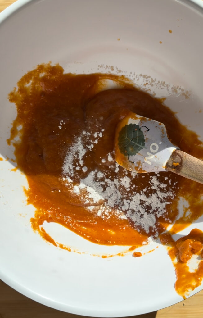 Baking powder, baking soda and salt sprinkled over the pumpkin mixture.