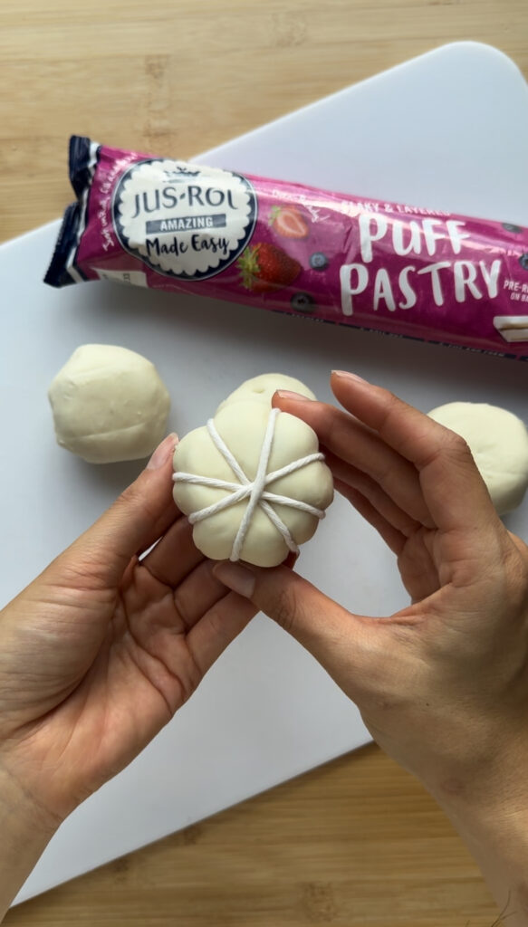 Wrapping kitchen twine around the ball of puff pastry 6 times.