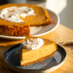 slice of pumpkin cheesecake on a blue plate.