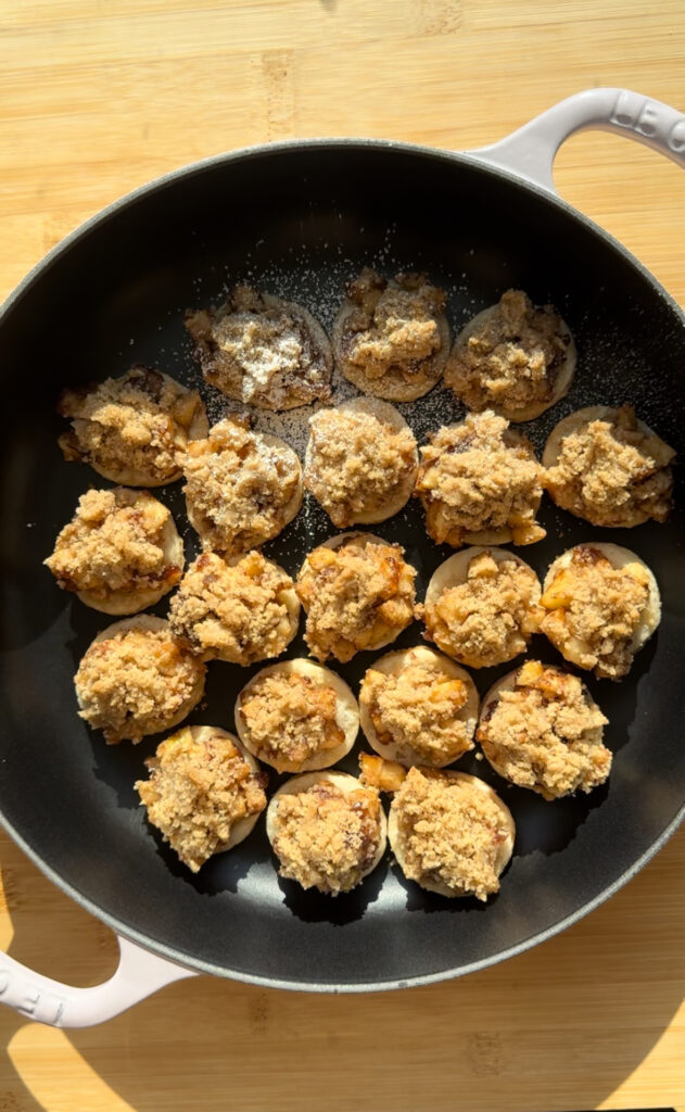Finished apple pie cookies in a pan.