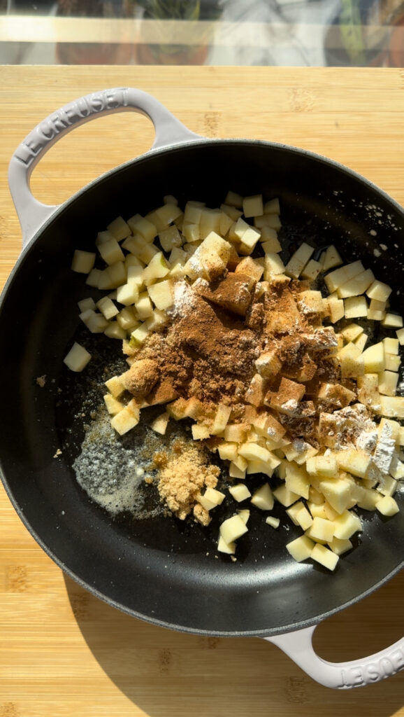 Apples and spices in a pan.