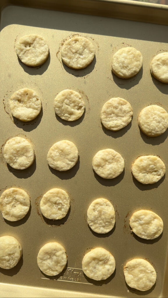 Baked pie dough circles on a baking sheet.