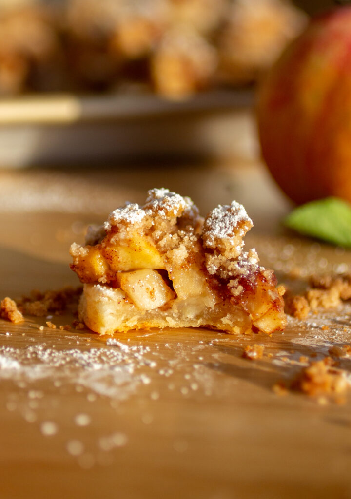A bite taken out of an apple pie cookie.
