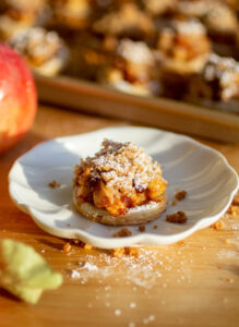 An apple pie cookie on a white plate.