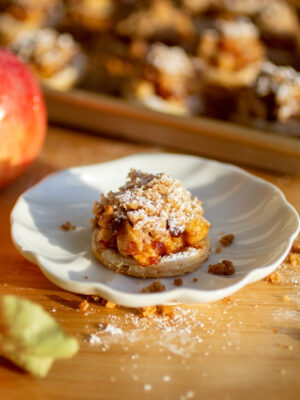 An apple pie cookie on a white plate.