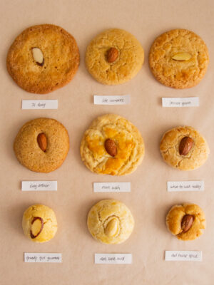 9 different Chinese almond cookies with labels on a pink background.
