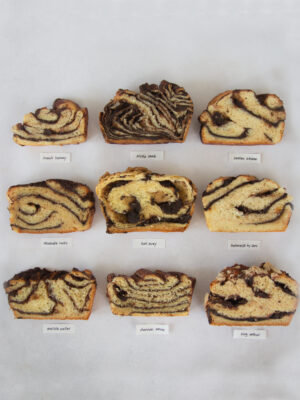 9 slices of chocolate babka with labels on a gray background.