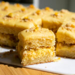 a slice of corn cake on a white cutting board.