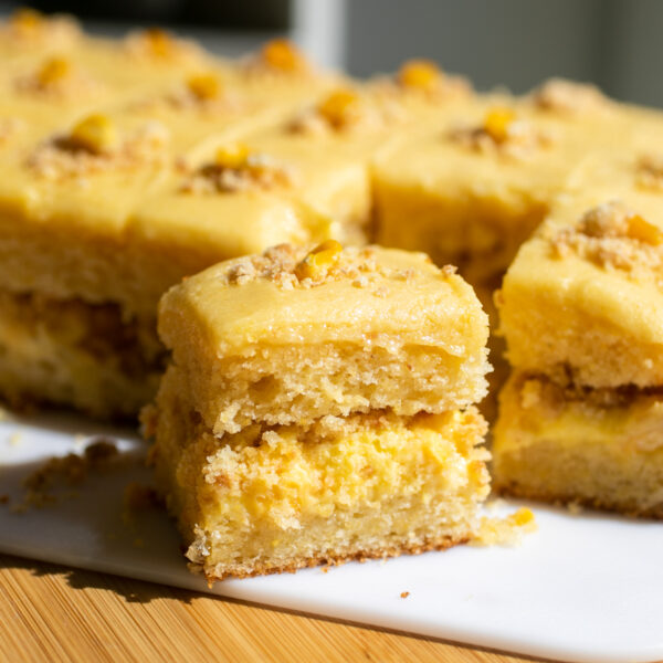 a slice of corn cake on a white cutting board.