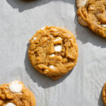 pumpkin white chocolate cookies on a baking sheet.