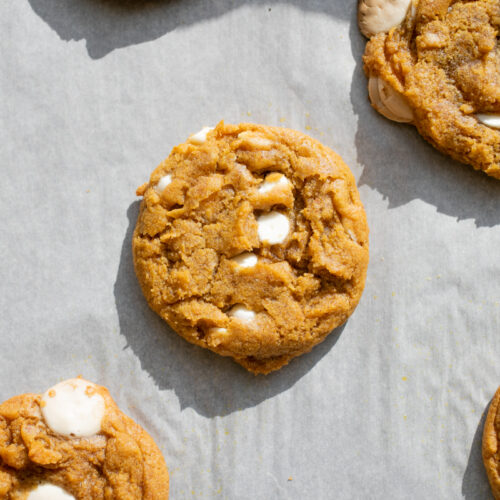 pumpkin white chocolate cookies on a baking sheet.
