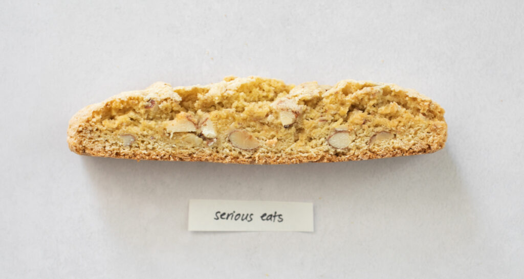 A pice of biscotti on a gray background with the label "Serious Eats."