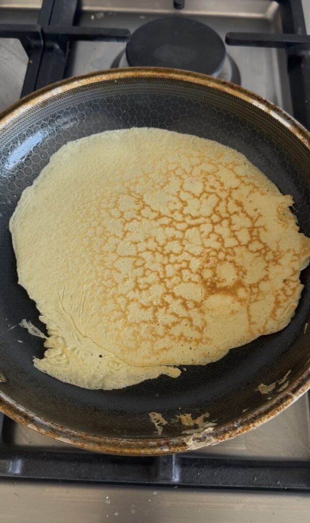 Cooked crepe in a pan.