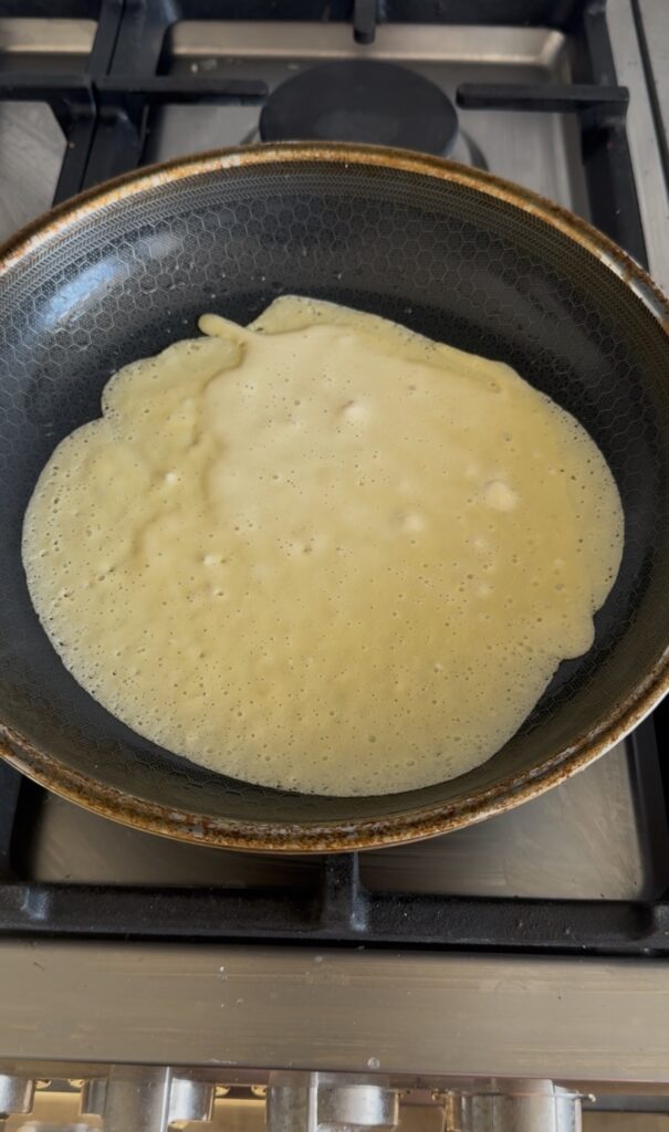 crepe batter in a pan.