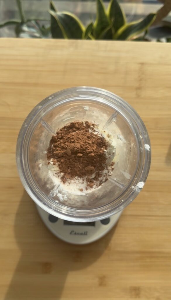 Ingredients for cheesecake in a blender.