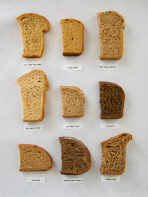 9 slices of whole wheat bread on a gray background.